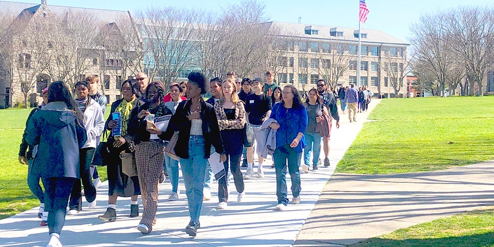 A tour group walking across URI quad during Welcome Day.